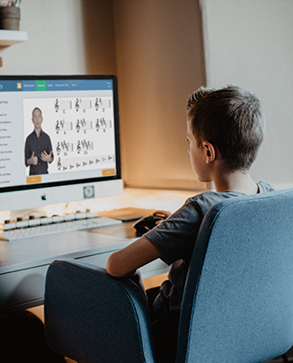 A student watches a video on writing key signatures in uTheory.